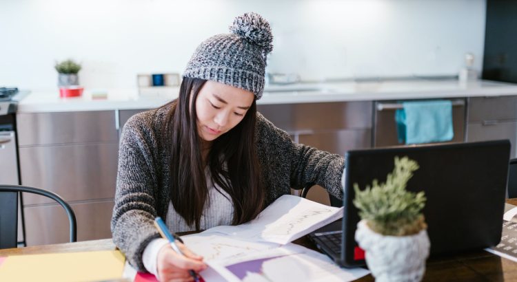 Woman in Hat Working with Statistical Data at Home Office