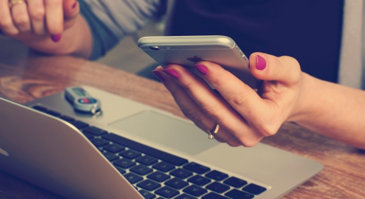 woman holding silver iPhone 6